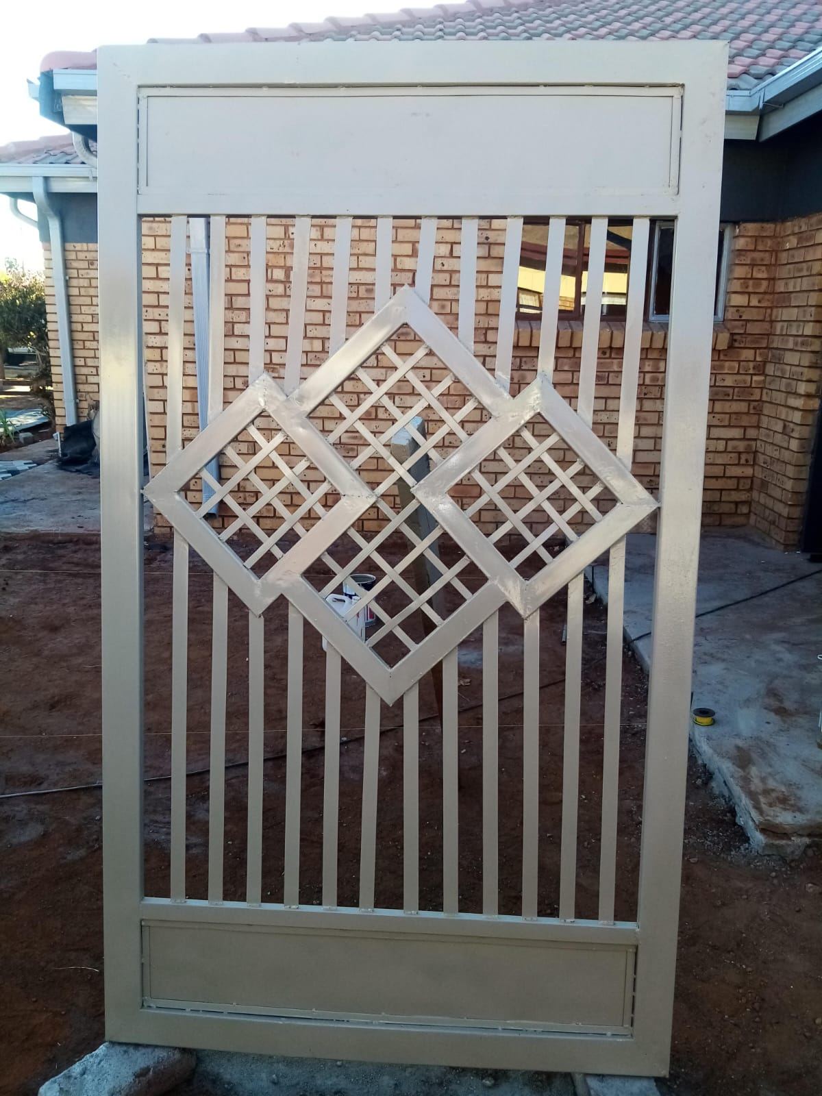 Custom fabricated steel pedestrian gate with a decorative panel