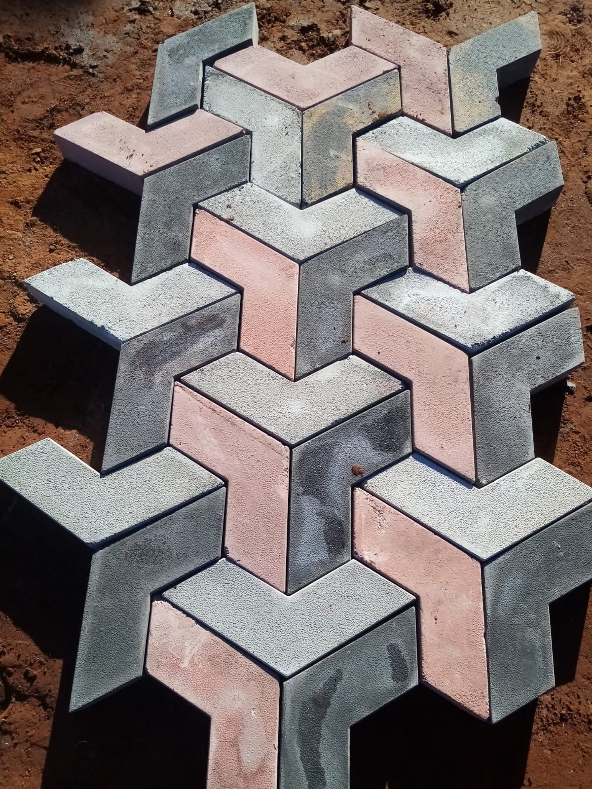 Close-up of grey and terracotta interlocking paving blocks