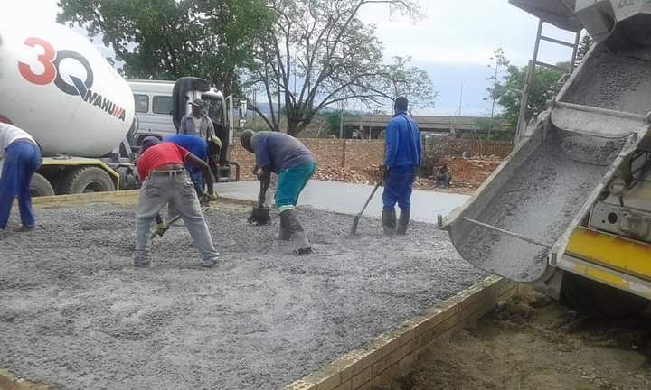 Bold T crew screeding a concrete surface bed